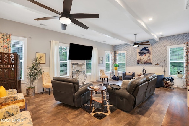 living room featuring dark hardwood / wood-style flooring, ceiling fan, and beamed ceiling