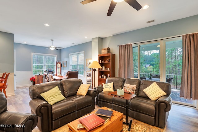 living room featuring ceiling fan and light hardwood / wood-style flooring