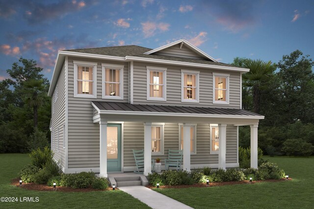 view of front of house featuring a yard and covered porch