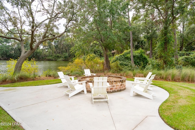 view of patio featuring a water view and an outdoor fire pit