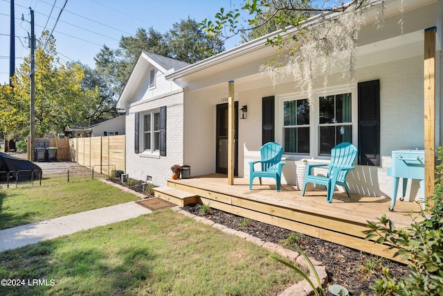 exterior space featuring a wooden deck and a yard