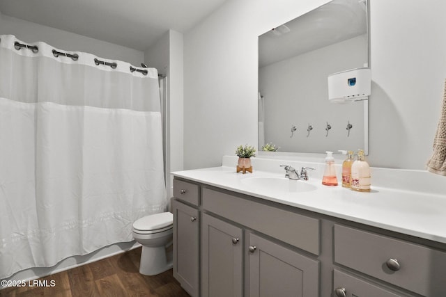 full bathroom featuring toilet, shower / tub combo with curtain, vanity, and wood finished floors