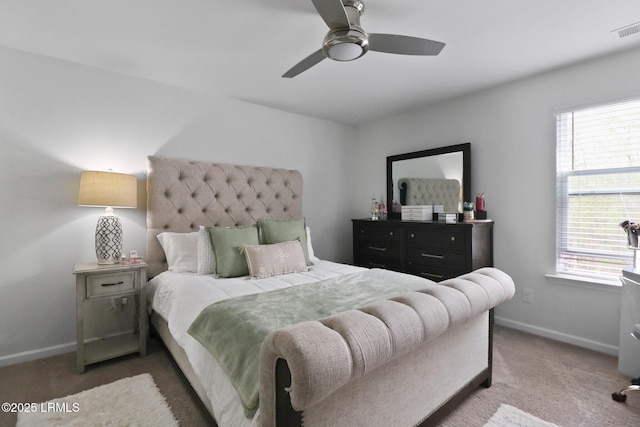 carpeted bedroom featuring baseboards, multiple windows, and visible vents