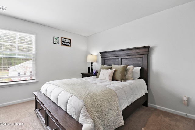 bedroom with carpet, visible vents, and baseboards