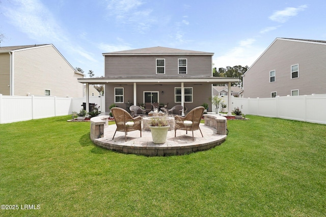 back of property with a patio area, a fenced backyard, and a yard