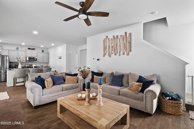 living room with dark wood-style flooring, a ceiling fan, and recessed lighting