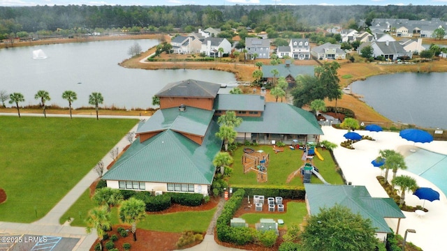 drone / aerial view featuring a water view and a residential view