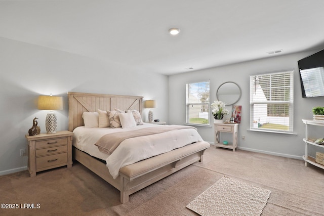carpeted bedroom with visible vents and baseboards