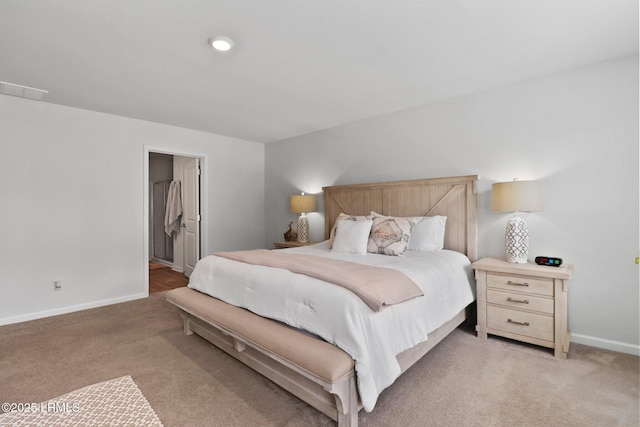 bedroom featuring visible vents, light colored carpet, and baseboards