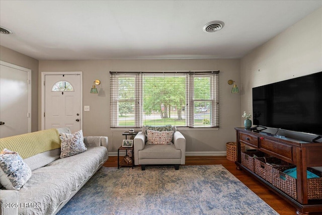 living area with wood finished floors and baseboards