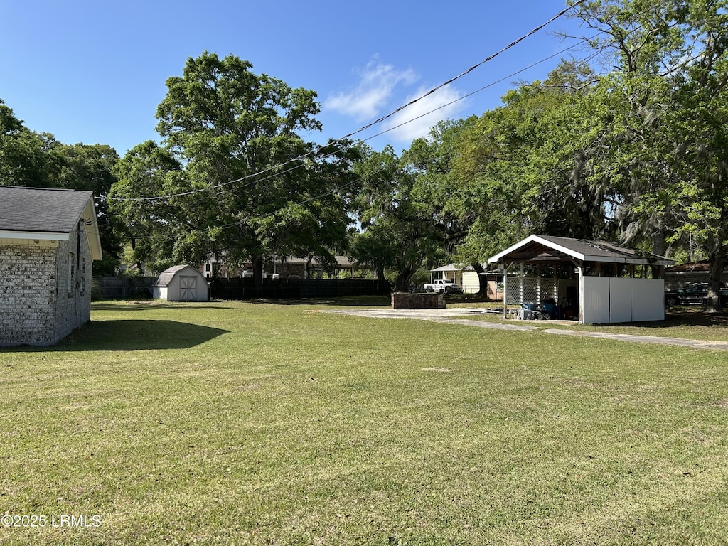 view of yard featuring a storage shed and an outbuilding