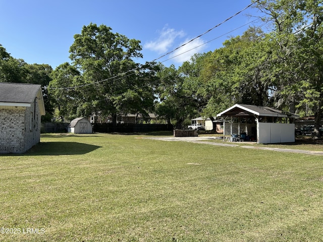 view of yard featuring a storage shed and an outbuilding