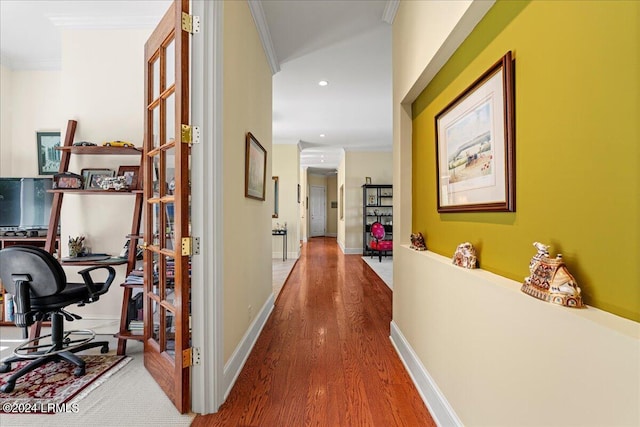 corridor featuring hardwood / wood-style flooring and ornamental molding