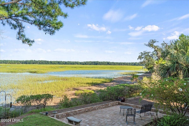 exterior space featuring a water view and a patio area