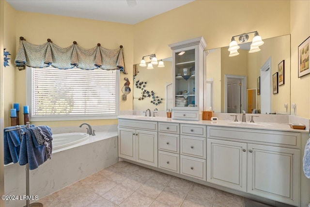 bathroom featuring tile patterned flooring, vanity, and a tub