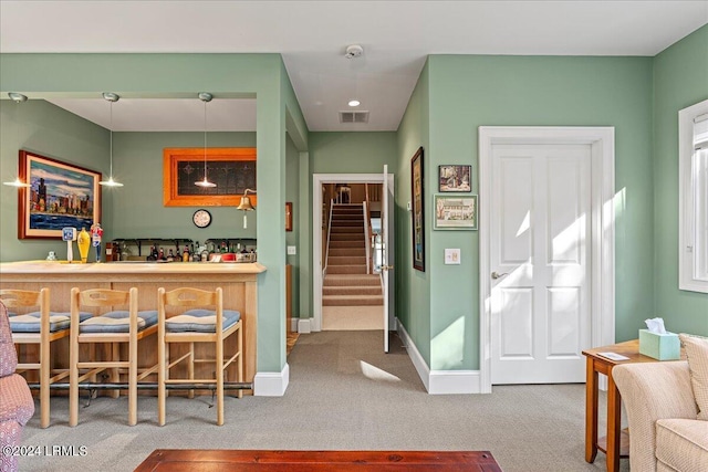 kitchen with hanging light fixtures and carpet floors