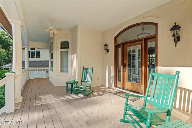 wooden terrace featuring ceiling fan and covered porch