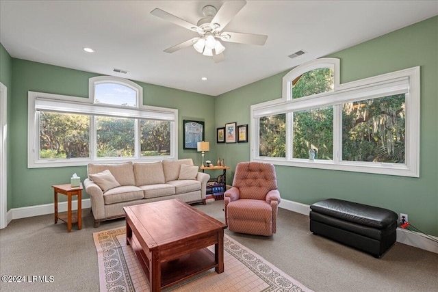 carpeted living room featuring a wealth of natural light and ceiling fan