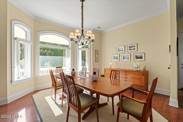 dining area featuring a notable chandelier, wood-type flooring, and ornamental molding