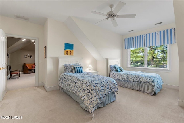 carpeted bedroom with ceiling fan and vaulted ceiling