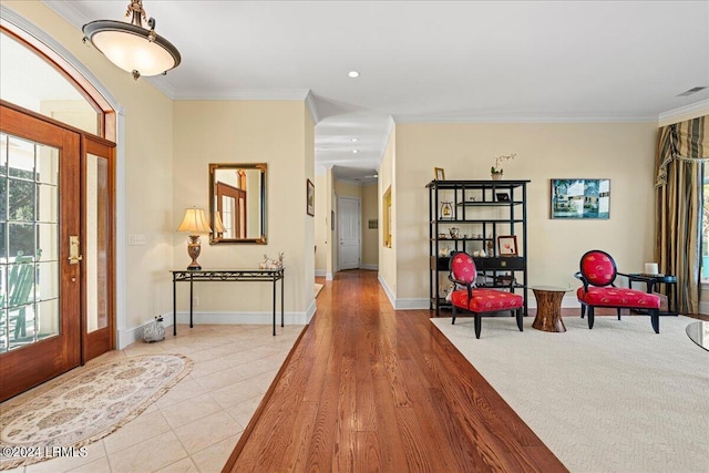 entrance foyer with light hardwood / wood-style flooring and ornamental molding