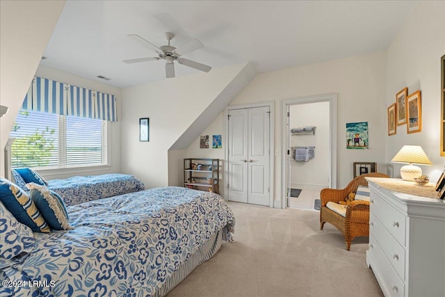 carpeted bedroom with ceiling fan and a closet