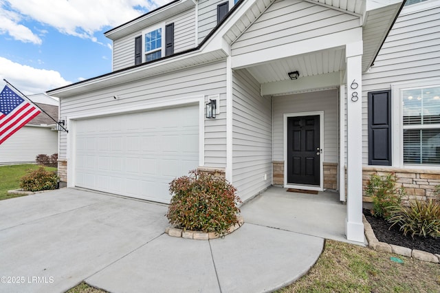 68 Keowee Ln, Beaufort, SC 29906 - doorway to property featuring an attached garage, stone siding, and driveway