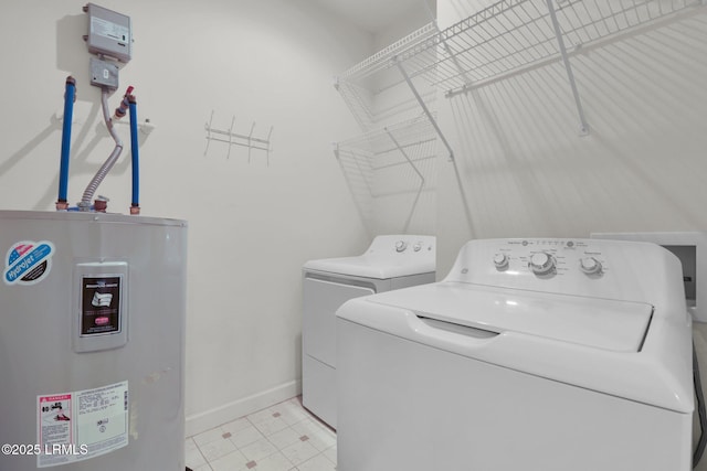 laundry room featuring laundry area, baseboards, washer and clothes dryer, water heater, and light tile patterned flooring