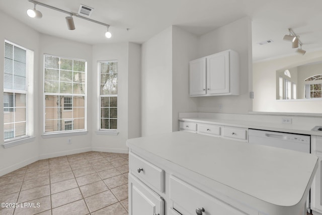 kitchen featuring light countertops, visible vents, white cabinetry, a kitchen island, and dishwasher