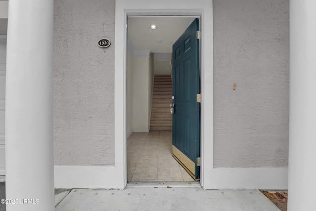 entrance to property with stucco siding