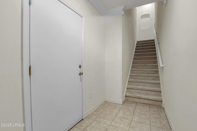 stairway with tile patterned flooring and baseboards