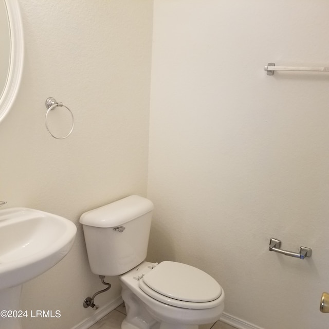 bathroom featuring sink, tile patterned floors, and toilet