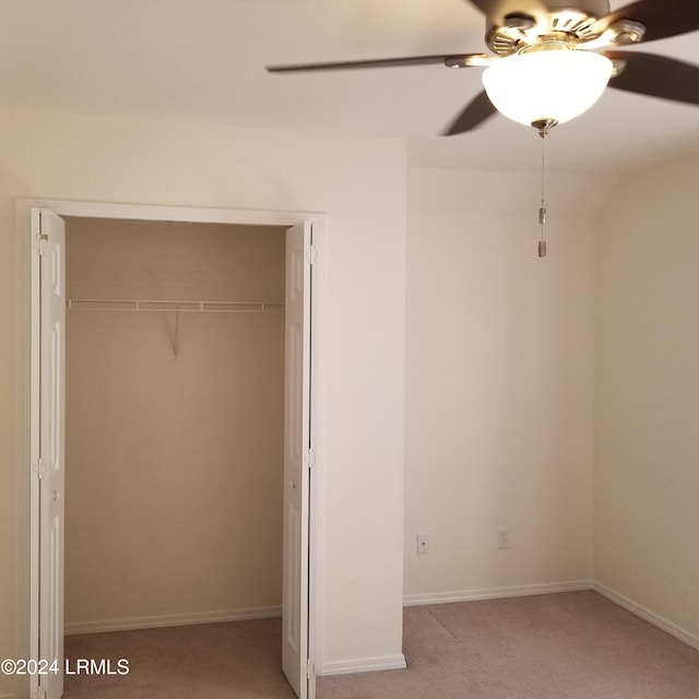 unfurnished bedroom with light colored carpet, ceiling fan, and a closet