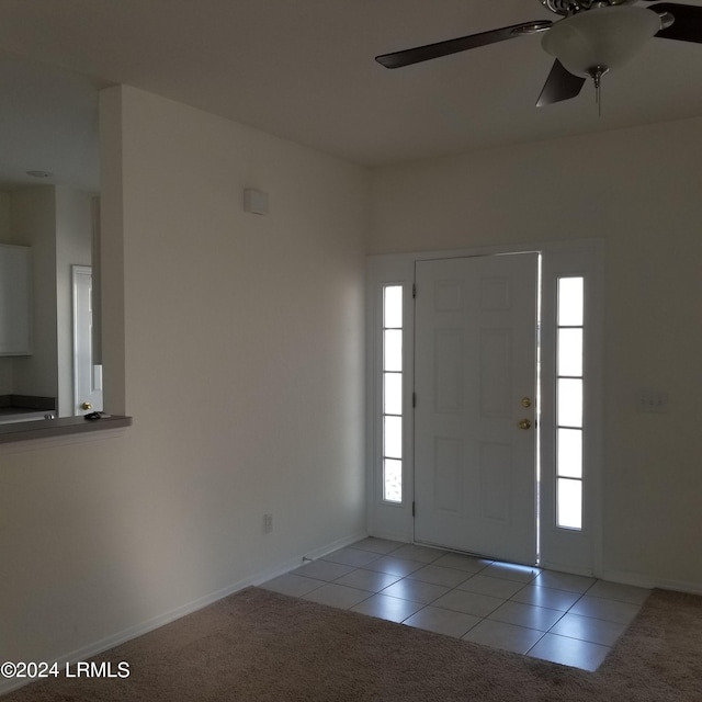 tiled entrance foyer with a healthy amount of sunlight and ceiling fan