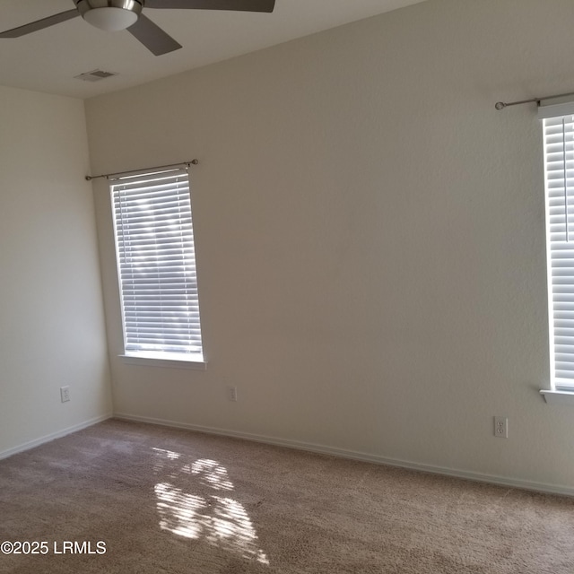 spare room featuring carpet flooring and ceiling fan