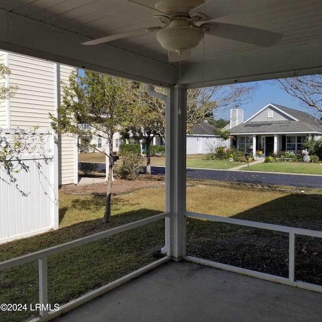 unfurnished sunroom featuring a wealth of natural light and ceiling fan