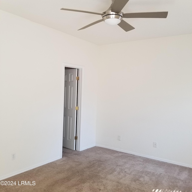 empty room with light colored carpet and ceiling fan