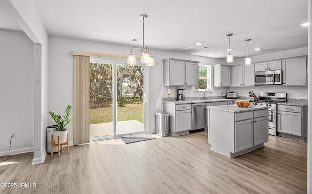128 Teal Bluff Blvd, Seabrook, SC 29940 - kitchen featuring stainless steel appliances, gray cabinetry, light wood-type flooring, recessed lighting, and a center island