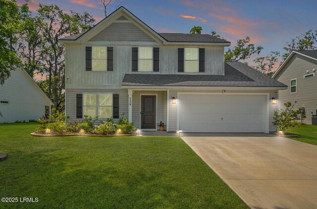 128 Teal Bluff Blvd, Seabrook, SC 29940 - view of front of property featuring driveway, a front lawn, a shingled roof, and an attached garage
