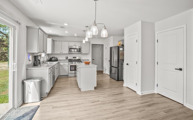 128 Teal Bluff Blvd, Seabrook, SC 29940 - kitchen featuring appliances with stainless steel finishes, gray cabinets, a center island, recessed lighting, and light wood finished floors