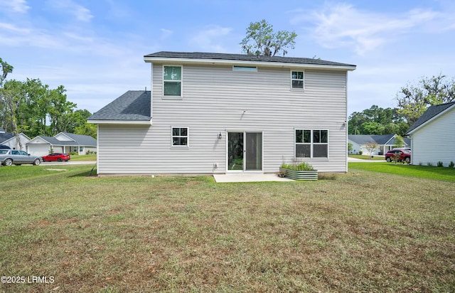 128 Teal Bluff Blvd, Seabrook, SC 29940 - rear view of house with a lawn and a patio