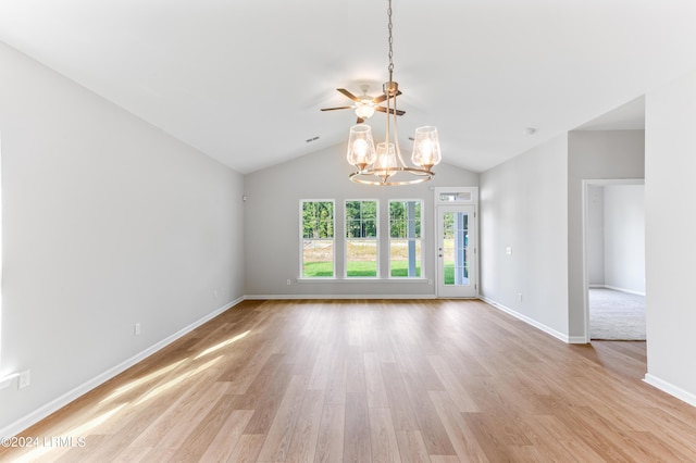 empty room featuring lofted ceiling, a chandelier, and light hardwood / wood-style flooring