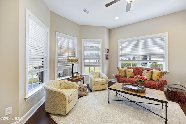 living room with wood-type flooring and ceiling fan