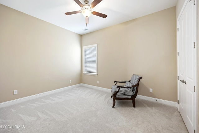 sitting room with light carpet and ceiling fan