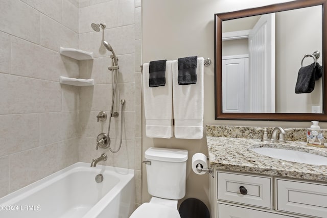 full bathroom with vanity, toilet, and tiled shower / bath combo