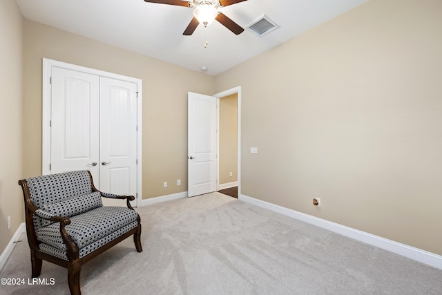 sitting room with light colored carpet and ceiling fan