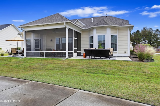 back of house featuring a patio area, a sunroom, and a lawn