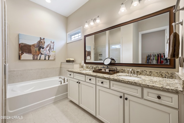 bathroom featuring vanity, a tub, and tile patterned floors