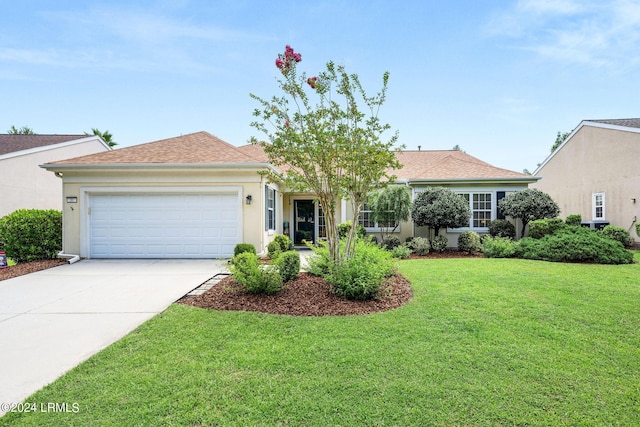 view of front of house featuring a garage and a front yard