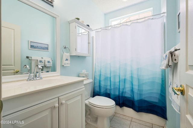 bathroom with vanity, toilet, tile patterned flooring, and a textured ceiling